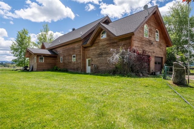 view of home's exterior with a garage and a lawn