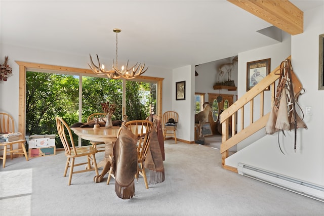 dining room featuring carpet flooring, an inviting chandelier, a baseboard radiator, and a wealth of natural light