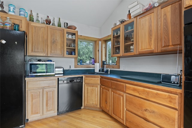 625 Middle Burnt Fork Rd, Stevensville, MT 59870 - kitchen with black appliances, lofted ceiling, light wood-style flooring, glass insert cabinets, and dark countertops