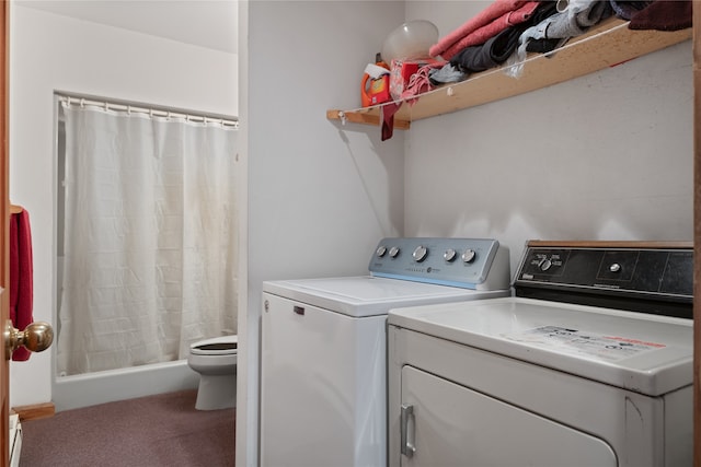 laundry room featuring washing machine and dryer and carpet