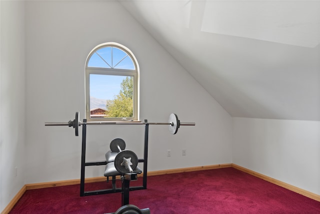 exercise room with carpet flooring and vaulted ceiling