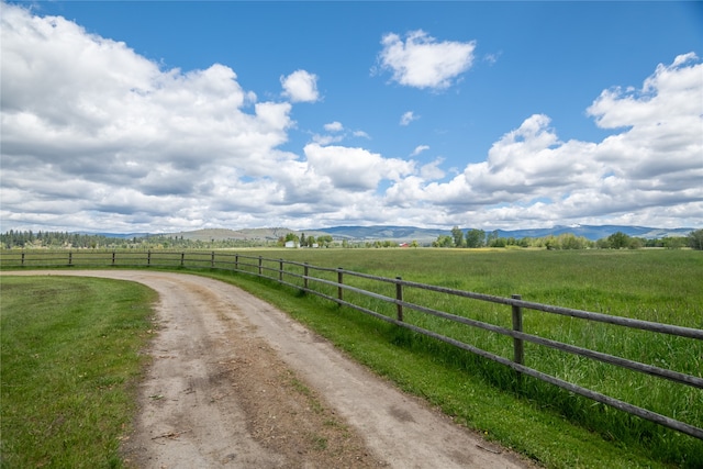 view of street with a rural view and a mountain view