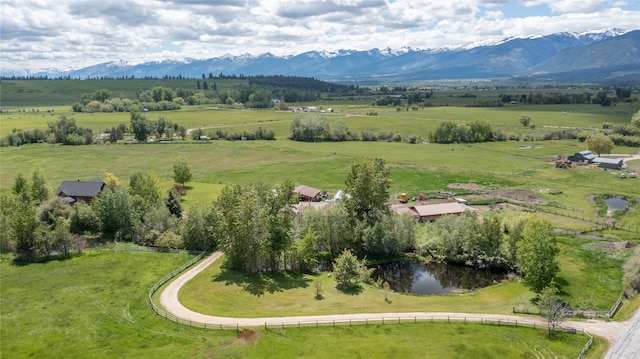 birds eye view of property featuring a mountain view and a rural view