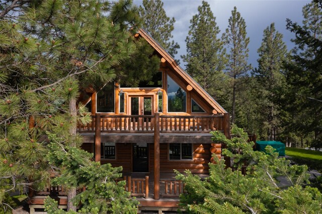 rear view of house featuring a deck