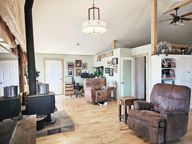 living room featuring light hardwood / wood-style flooring, ceiling fan, and high vaulted ceiling