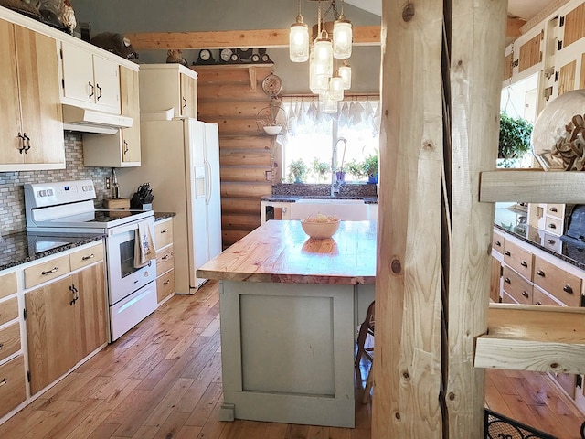 kitchen featuring a healthy amount of sunlight, white appliances, light wood-type flooring, and rustic walls