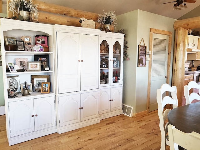 interior space featuring light hardwood / wood-style floors, stainless steel range oven, and ceiling fan