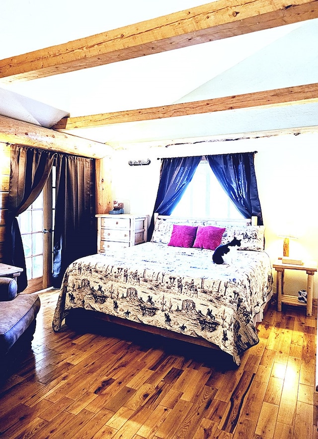 bedroom with hardwood / wood-style flooring and lofted ceiling with beams