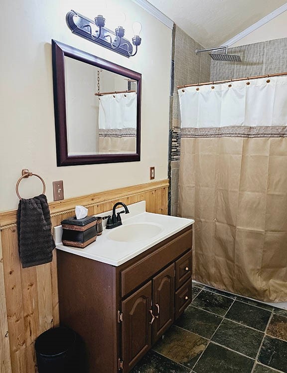 bathroom featuring vanity, crown molding, and tile patterned flooring