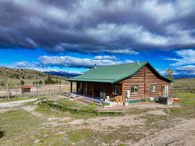 back of house with a rural view