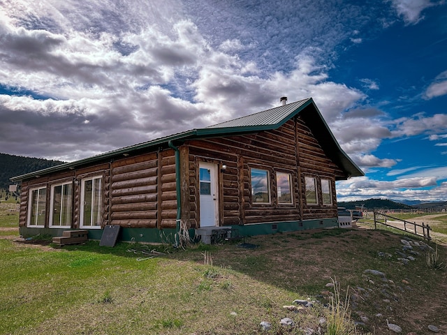 view of side of home featuring a lawn