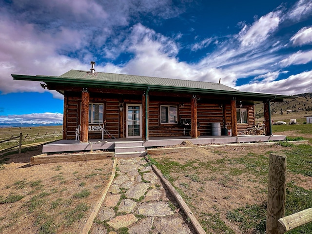 back of property with covered porch