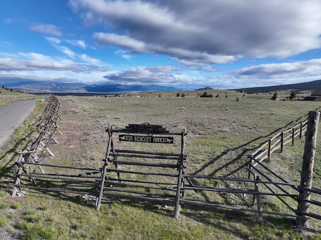 view of yard with a mountain view and a rural view