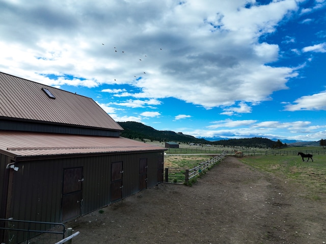 view of side of property with a mountain view and a rural view