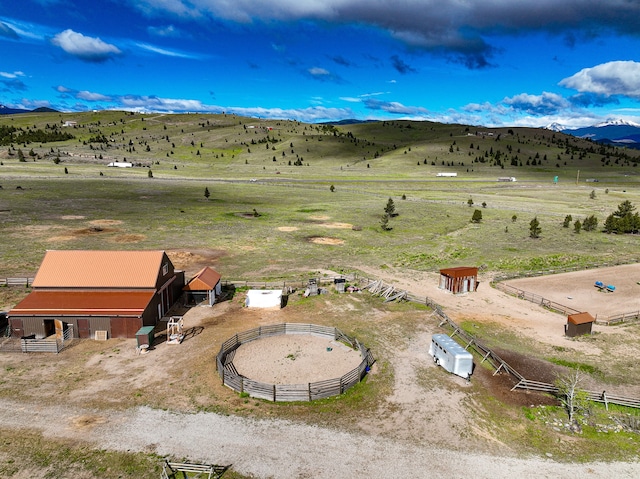 drone / aerial view with a mountain view and a rural view