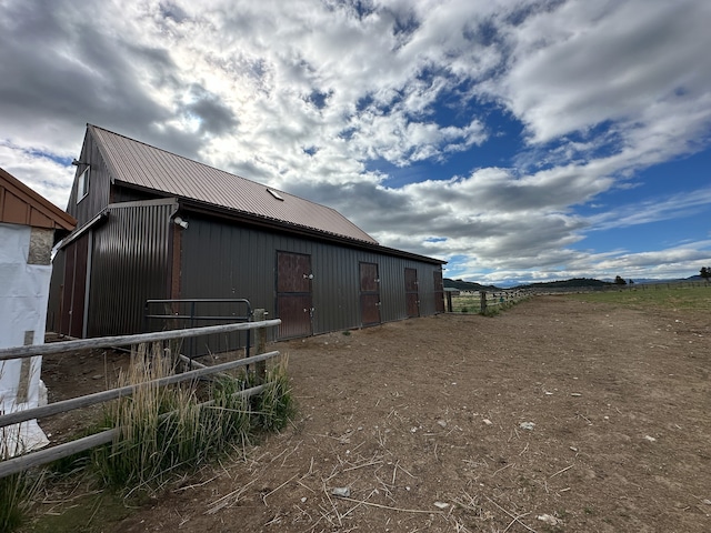 view of horse barn with an outbuilding