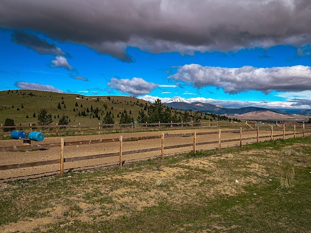 view of yard featuring a mountain view and a rural view