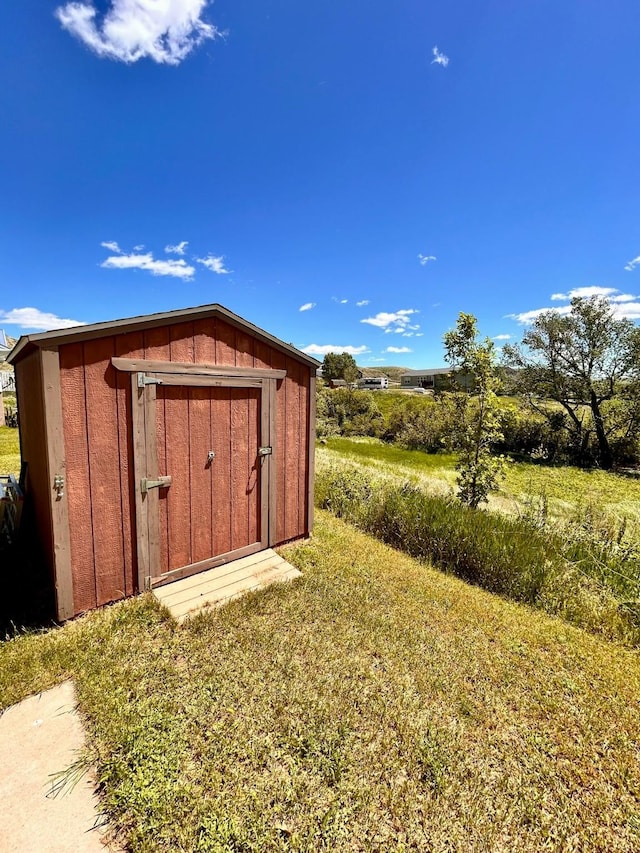 view of outbuilding featuring a lawn