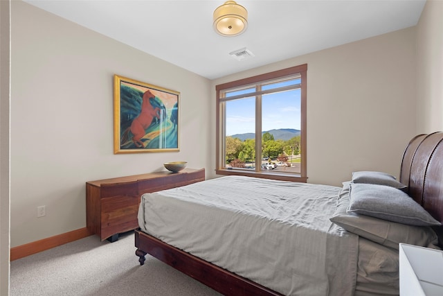 bedroom featuring a mountain view and carpet