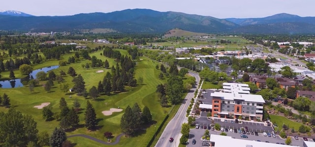 drone / aerial view featuring a water and mountain view