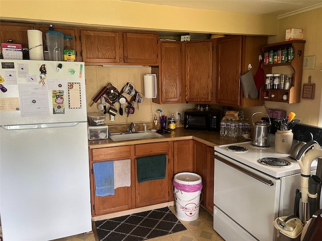 kitchen featuring white appliances and sink