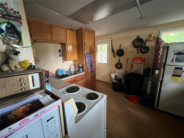 kitchen with white electric range oven, a paneled ceiling, washer / clothes dryer, and stainless steel refrigerator