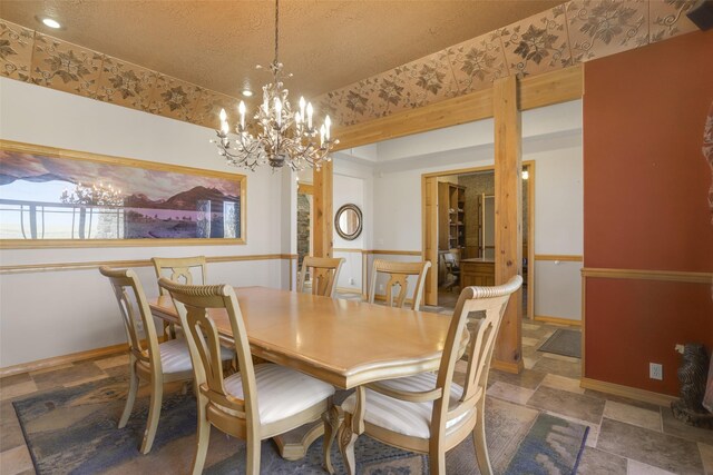 tiled dining space featuring an inviting chandelier and a textured ceiling