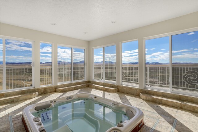 unfurnished sunroom featuring a jacuzzi