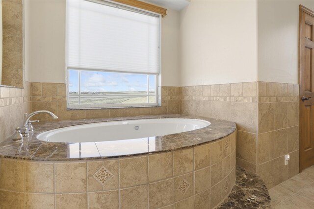 bathroom with tile floors and a relaxing tiled bath