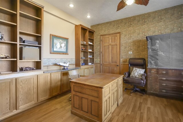 office featuring ceiling fan, a textured ceiling, and light wood-type flooring