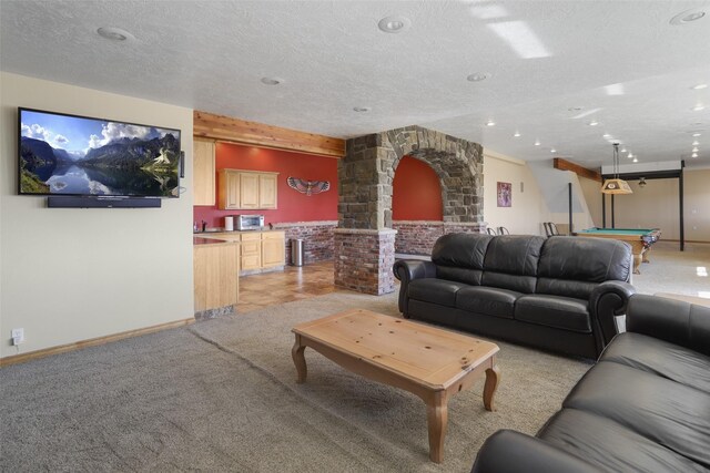 living room featuring light colored carpet, pool table, and a textured ceiling