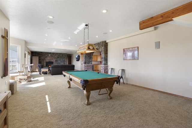 playroom featuring a stone fireplace, carpet floors, beam ceiling, a textured ceiling, and billiards