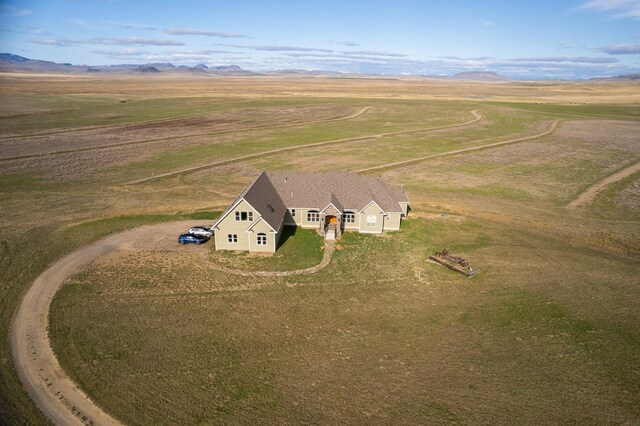 view of front of home with a front yard and a rural view