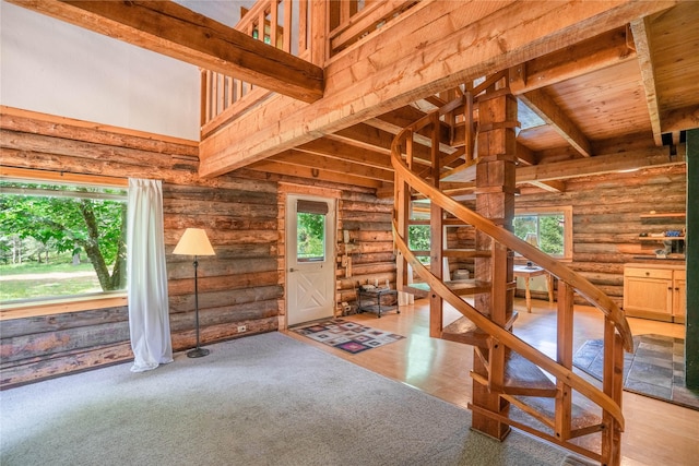 interior space with beam ceiling and a high ceiling