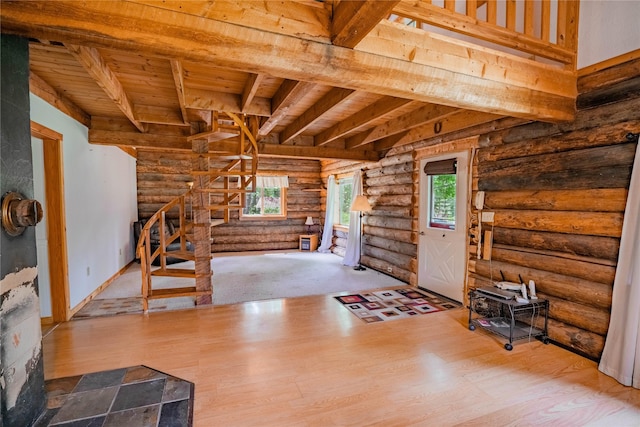 interior space featuring wood ceiling, wood finished floors, beamed ceiling, and stairs