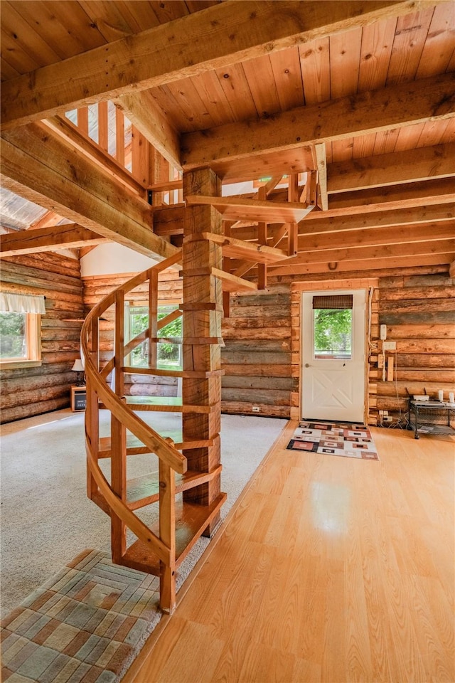 interior space featuring wood ceiling, wood finished floors, and beam ceiling