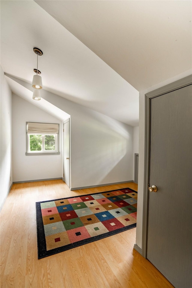 bonus room with vaulted ceiling and wood finished floors