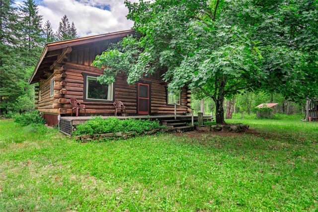 view of side of home featuring a lawn