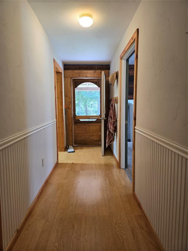 corridor with wainscoting and light wood-style floors