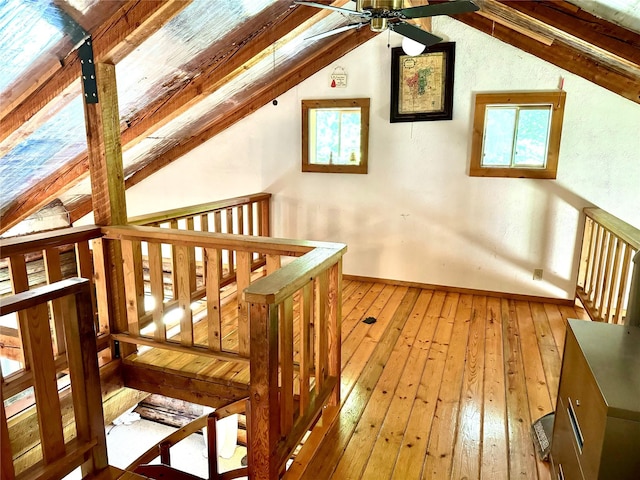 bonus room featuring lofted ceiling, baseboards, a ceiling fan, and light wood-style floors