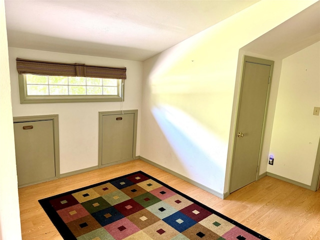 entryway with light wood-style floors and baseboards