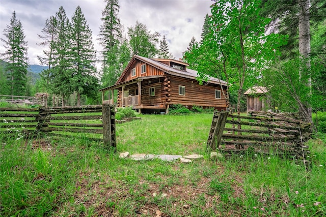 exterior space featuring fence and log siding