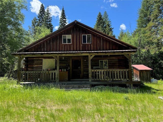 log home featuring log exterior, a porch, and board and batten siding