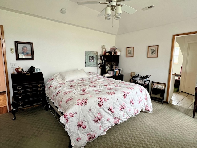 carpeted bedroom featuring ceiling fan and vaulted ceiling