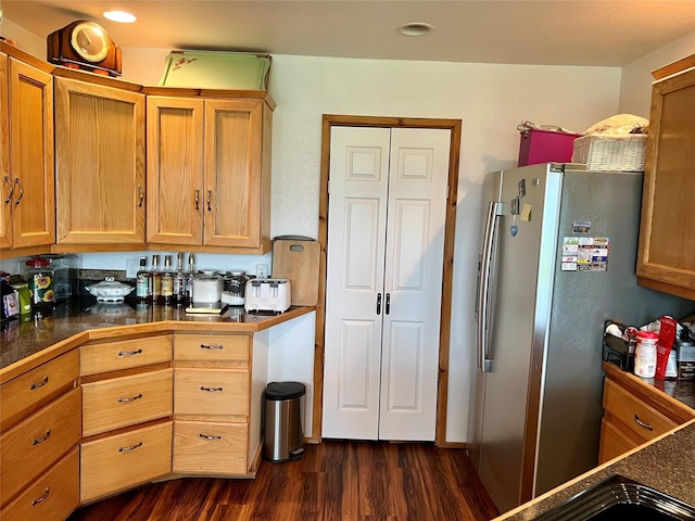 kitchen featuring stainless steel fridge and dark hardwood / wood-style flooring