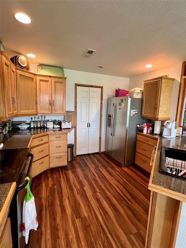 kitchen with electric range, dark hardwood / wood-style floors, stainless steel fridge with ice dispenser, and a textured ceiling