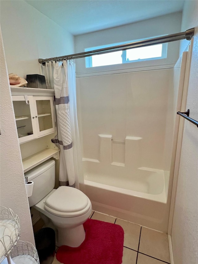 bathroom with toilet, shower / tub combo, and tile patterned flooring