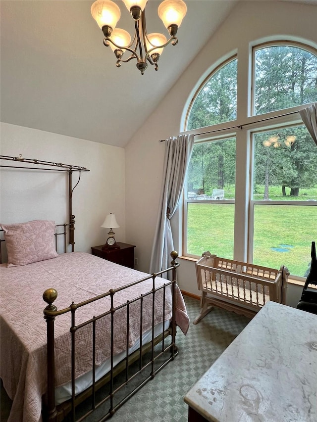 bedroom featuring multiple windows, a chandelier, and vaulted ceiling