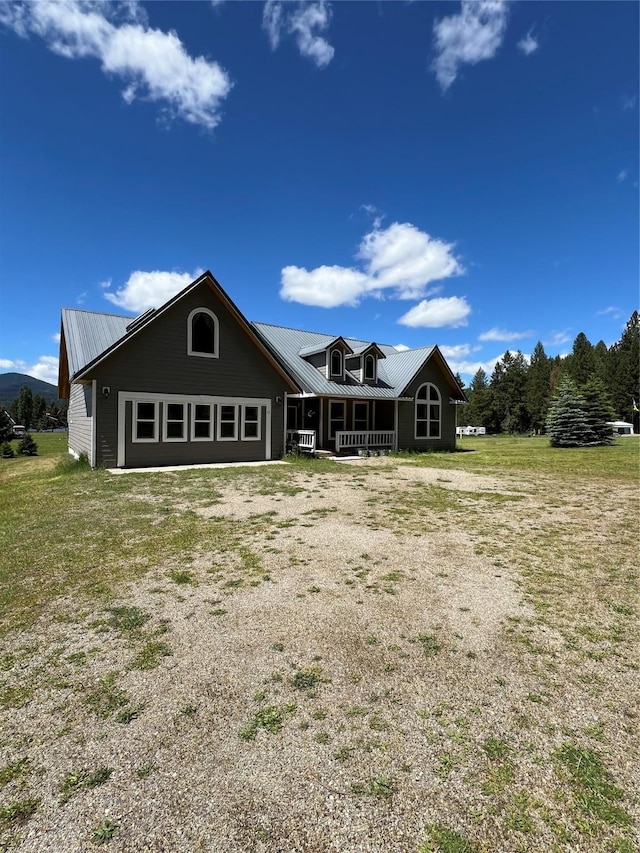 rear view of property featuring a lawn