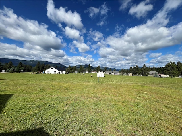 view of yard with a storage unit and a mountain view